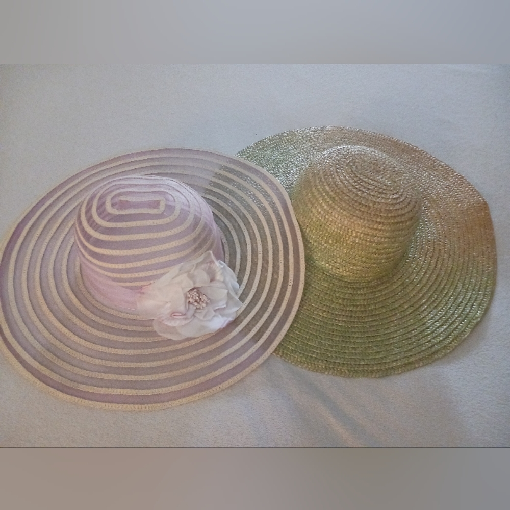 2 sun hats - a pink sun hat and a green/natural straw sun hat.